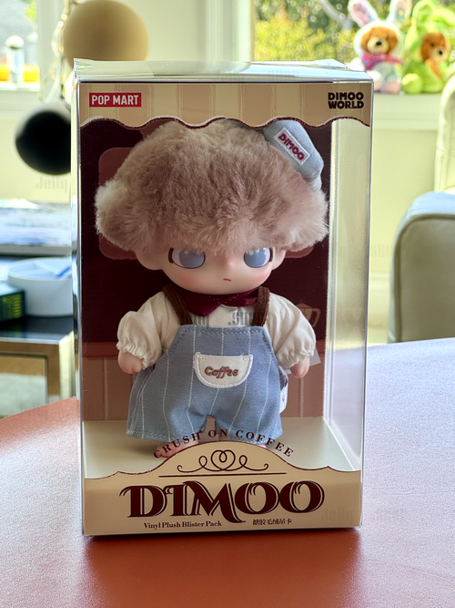 open box POP MART DIMOO plush figure in packaging with soft features and coffee-themed attire